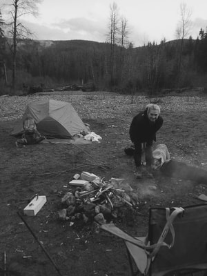 Bertha and Mikayla helping set up the fire for camping!